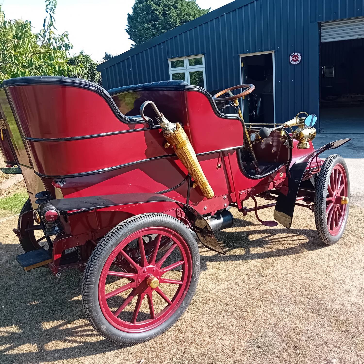 Rear three-quarter view, with the wicker-cased umbrella mounted on the body