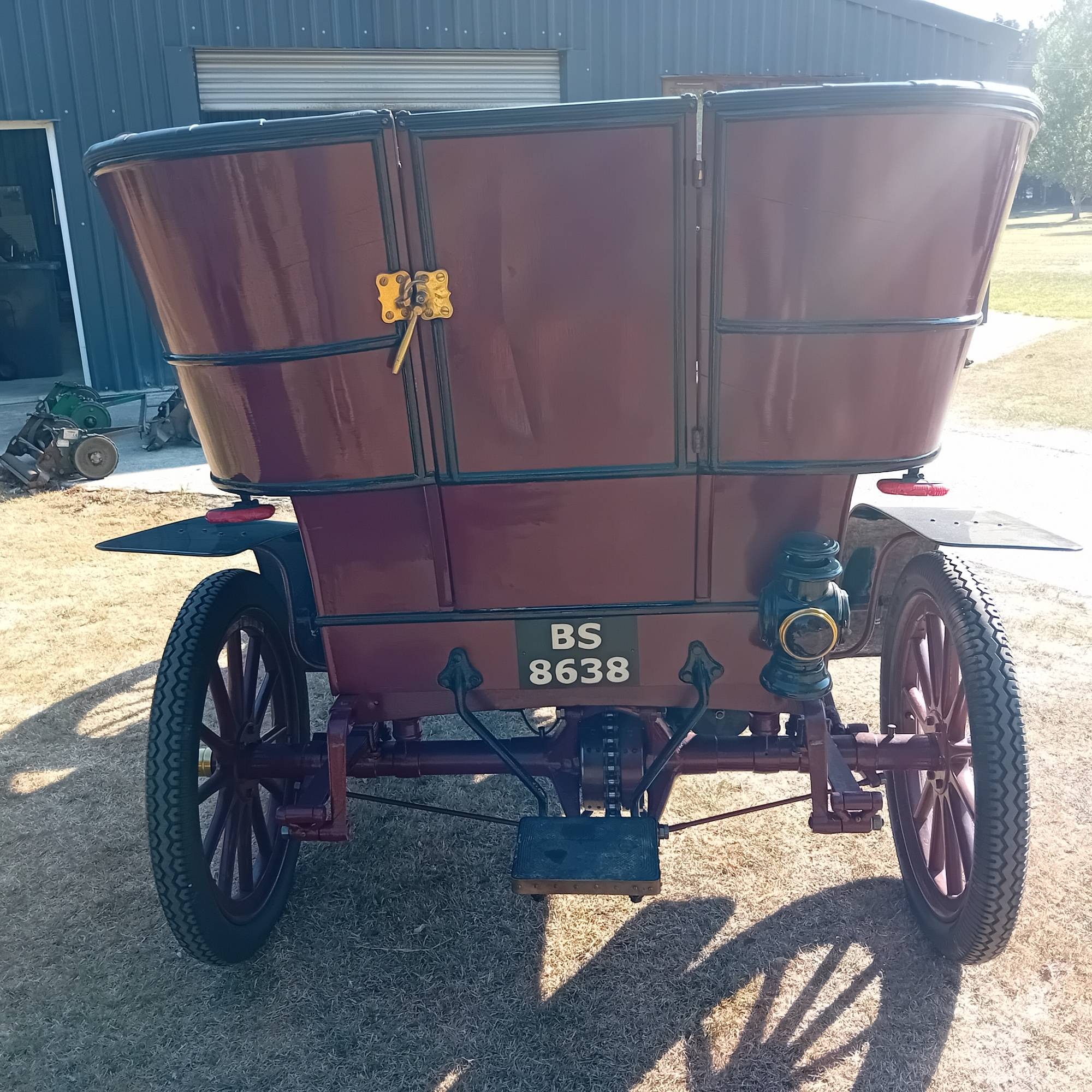 Rear view of the tonneau, showing the entrance doors, step, and chain drive