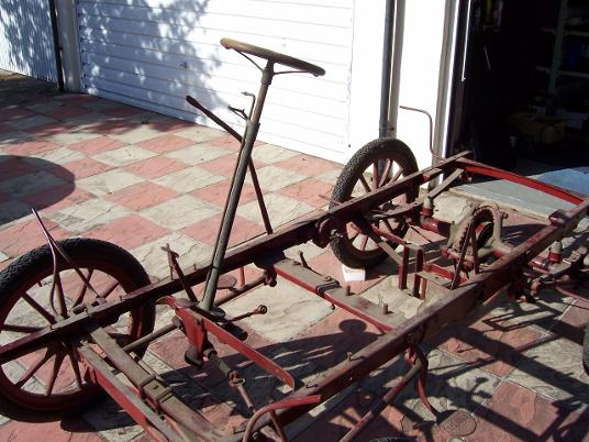 The bare chassis with steering column and wheels during restoration